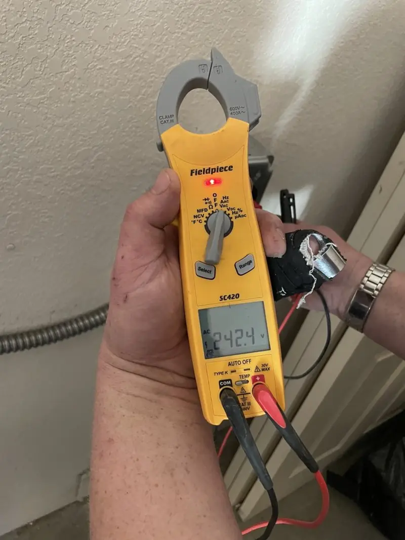 Voltage testing with clamp meter during Outlet Installation in West Vincent